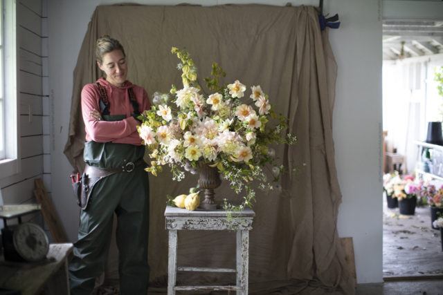 Erin Benzakein arranging in the Floret studio wearing Grundens rain gear